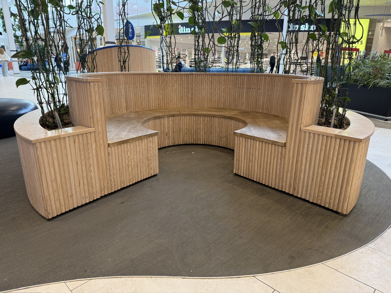 Curved bench in a shopping mall with an opening left in its circle